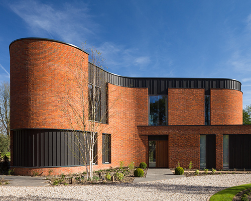 adrian james architects builds sinuous 'incurvo' brick house in rural oxfordshire