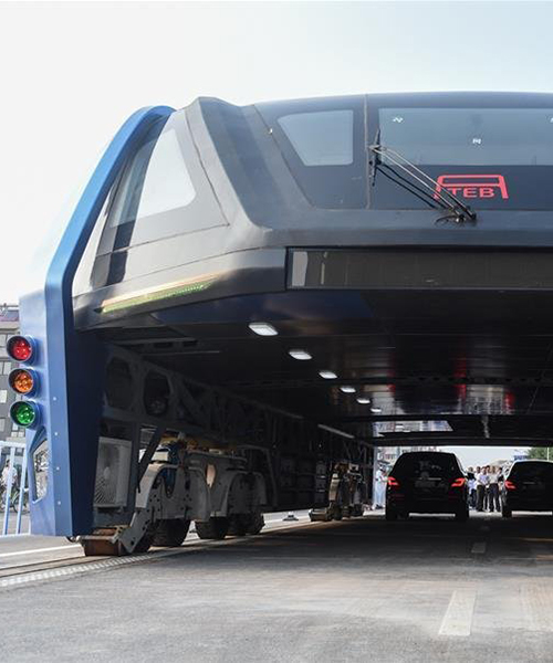 giant elevated bus straddles and soars over cars in first test drive in china