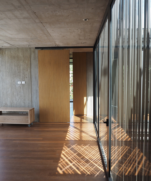 guillermo fisher adds central patio to cantilevered house in bogotá