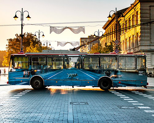 liudas parulskis' vanishing trolleybus blends into the urban landscape of vilnius, lithuania