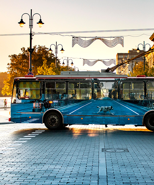 liudas parulskis' vanishing trolleybus blends into the urban landscape of vilnius, lithuania