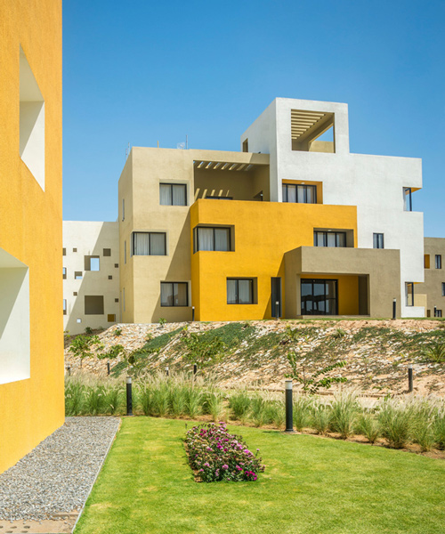 sanjay puri architects develops housing project in india as deconstructed yellow cubes