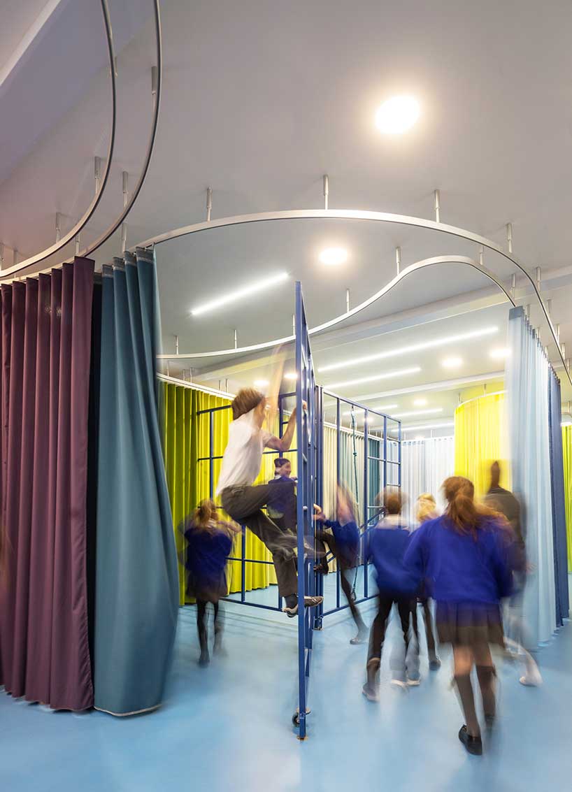 aberrant architecture reconfigures london school with sculptural rails and colored curtains