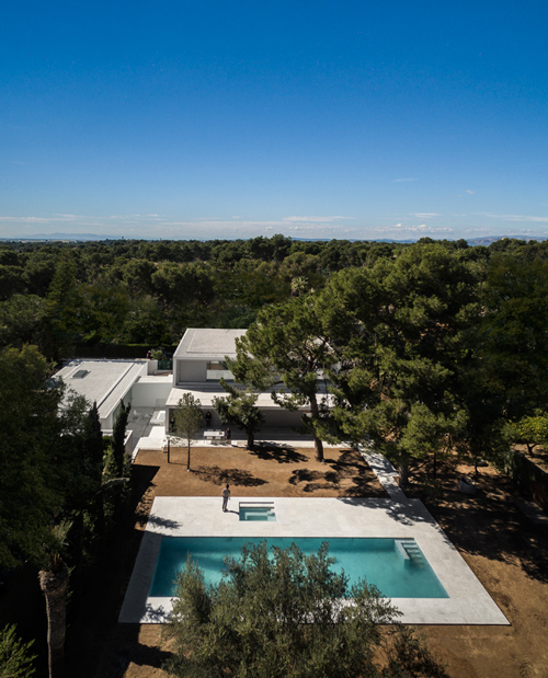 fran silvestre nestles expansive pool house in the woods of valencia