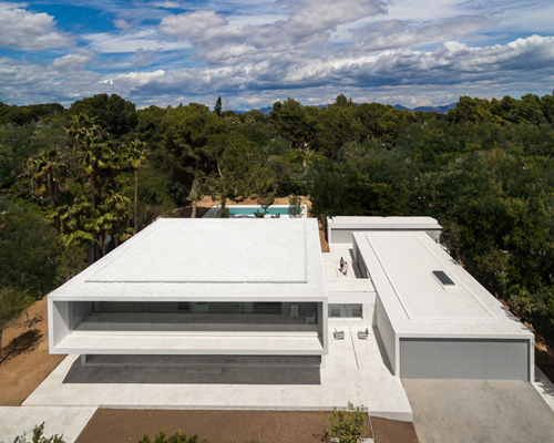 fran silvestre nestles expansive pool house in the woods of valencia