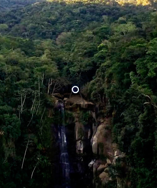 mariko mori sites luminous ring at the peak of a cascading waterfall in brazil