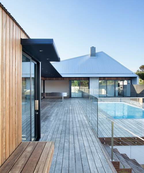 vibe design group covers house in melbourne with asymmetric steel roof