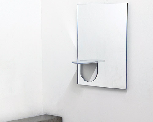 the U mirror by studio yumakano features a functional folded shelf