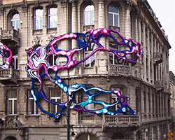 crystal wagner wraps an amorphous growth around art nouveau building in łódź