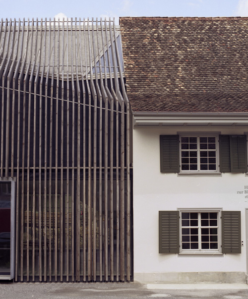 marazzi reinhardt slots farmhouse intervention between traditional swiss buildings