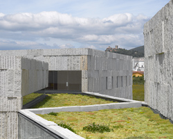 zooco estudio builds an arts and culture center in spain formed of six stone-clad volumes