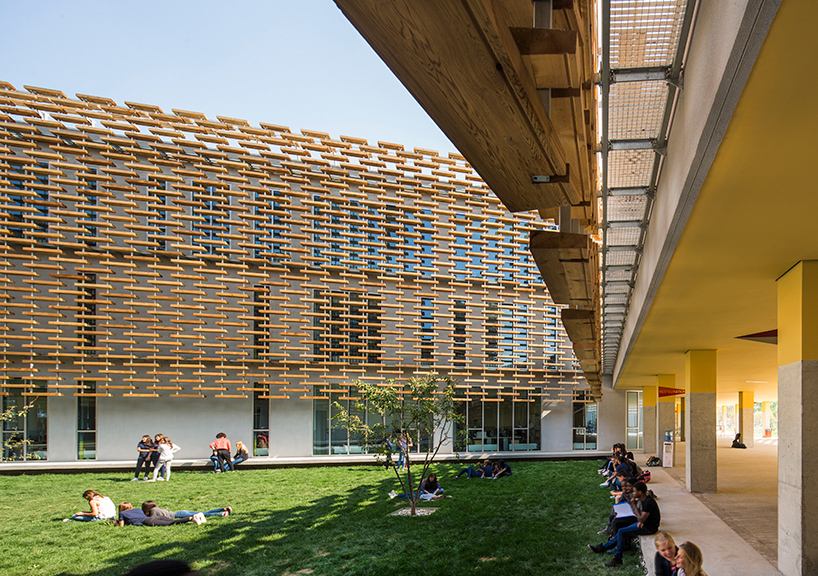 jacques ferrier wraps a wooden lattice around the french international school of beijing