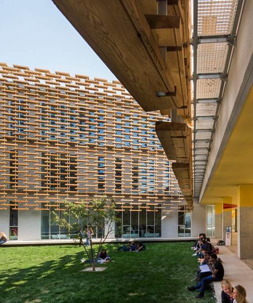 jacques ferrier wraps a wooden lattice around the french international school of beijing