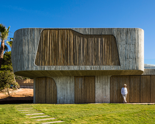 metroarea architetti clads villa in ibiza with board formed concrete and bamboo shutters