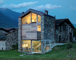 rocco borromini adds timber façade to stone ruins to create SV house in northern italy