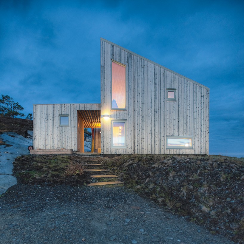 TYIN tegnestue architects embeds timber cottage into the rugged terrain in norway