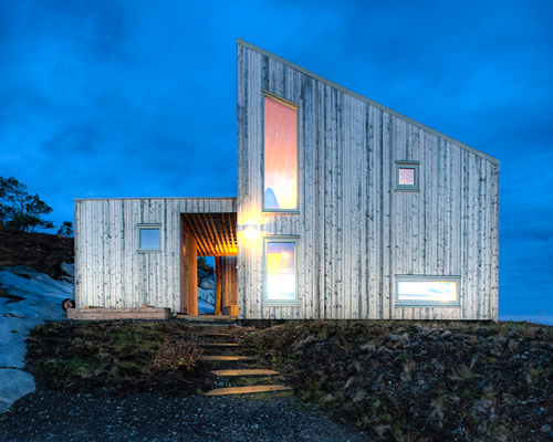 TYIN tegnestue architects embeds timber cottage into the rugged terrain in norway