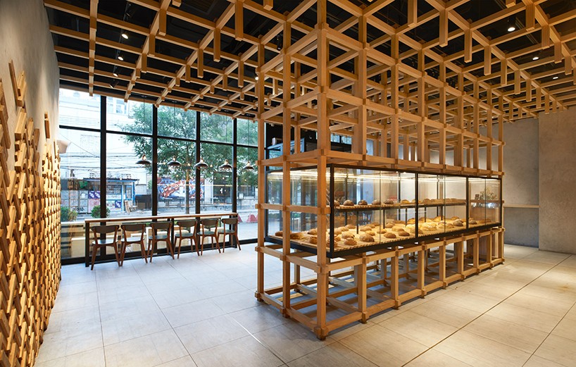 B.L.U.E architecture studio builds timber framework inside bakery in beijing