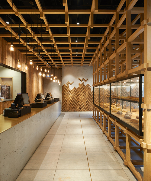 B.L.U.E architecture studio builds timber framework inside bakery in beijing