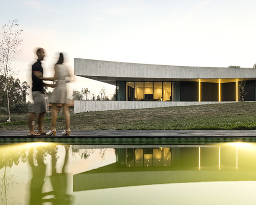 spaceworkers' cabo de vila house in portugal features mirrored concave sides