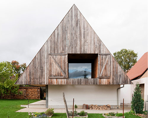 gens conceals contemporary disneyland home in traditional gabled roof