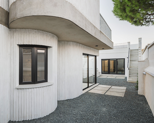 studio wet adds curving concrete walls to extension in seville