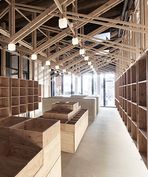 inverted trusses inserted inside historic dry-goods store in taiwan