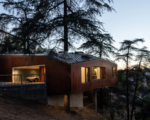 cantilevered dwelling by anonymous architects exists amid the trees in los angeles