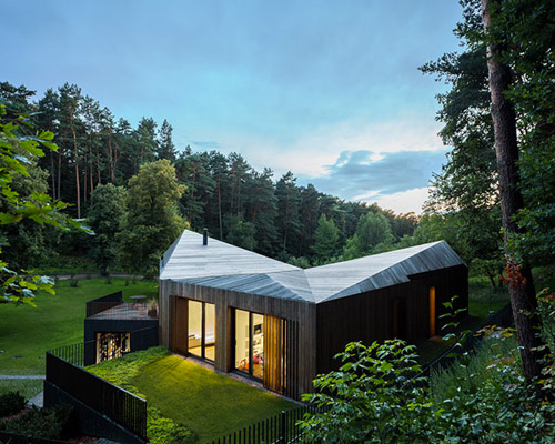 arches cantilevers wooden house in lithuanian valley