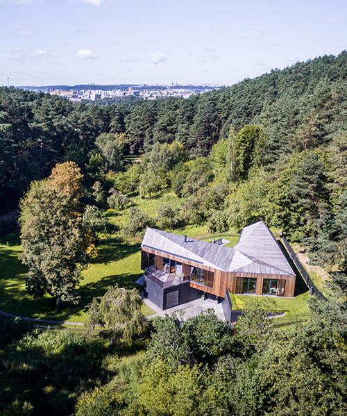 arches cantilevers wooden house in lithuanian valley