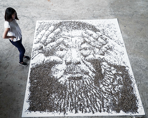 red hong yi spreads 20,000 seeds across a canvas to create a larger-than-life portrait of ai weiwei