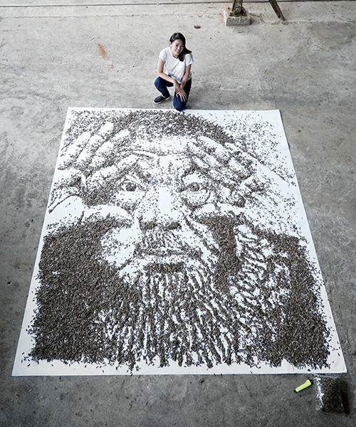 red hong yi spreads 20,000 seeds across a canvas to create a larger-than-life portrait of ai weiwei