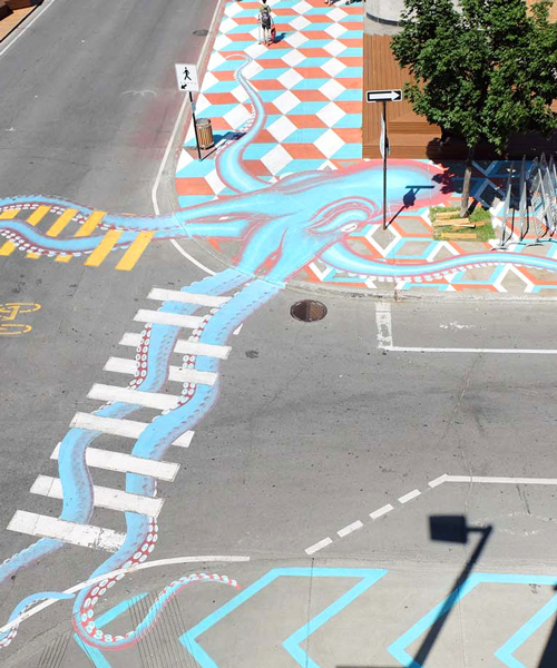 roadsworth adds to asphalt with surreal street art scenes