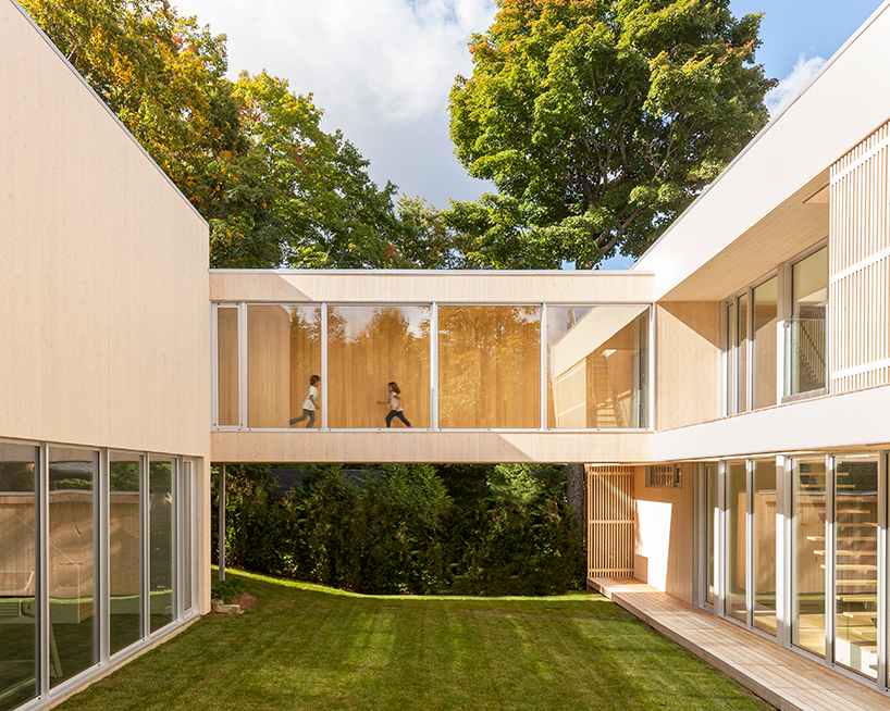 atelier pierre thibault connects expansive lake home with footbridge