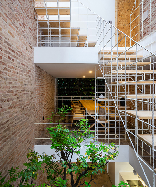 white grid inserted into vietnamese townhouse by block architects