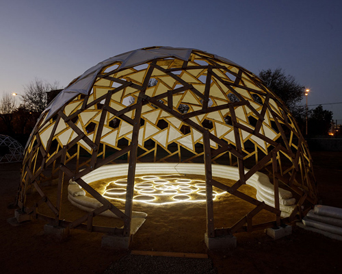 collaborative team builds twin domes in an orchard using geodesic + adobe techniques