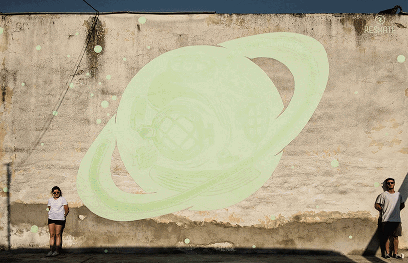 glow-in-the-dark street art by reskate studio reveals secret messages by night