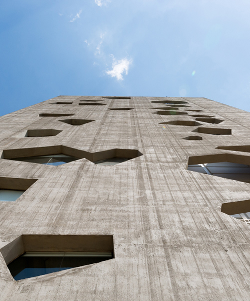 morini arquitectos constructs concrete tower in argentina with irregular apertures