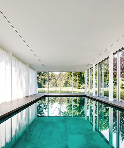 MEER architekten embeds private poolhouse as a glazed pavilion in ismaning, munich