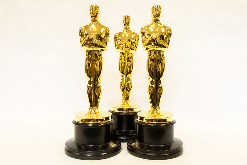 Who Is the Oscar Statue Modeled After and What Is it Holding?