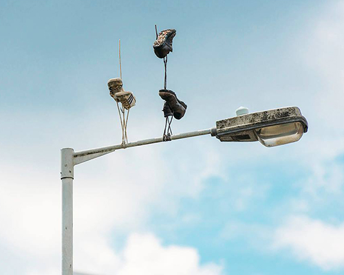 pejac's gravity-defying sneakers create surreal scenes on the streets of london
