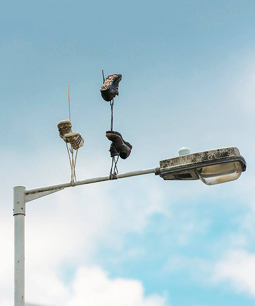 pejac's gravity-defying sneakers create surreal scenes on the streets of london