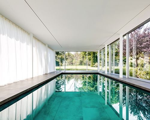 MEER architekten embeds private poolhouse as a glazed pavilion in ismaning, munich