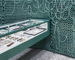 wall of knitted wires seen inside eyeglass store in seoul by wallga + WGNB