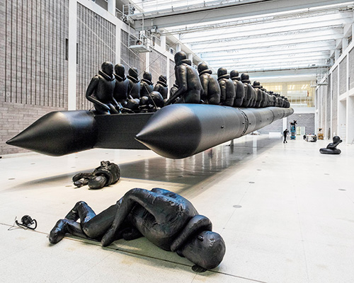 hundreds of figures squeeze into ai weiwei's suspended rubber raft at the national gallery, prague