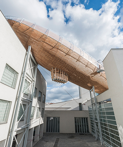 hut architektury lands giant airship atop of DOX in prague