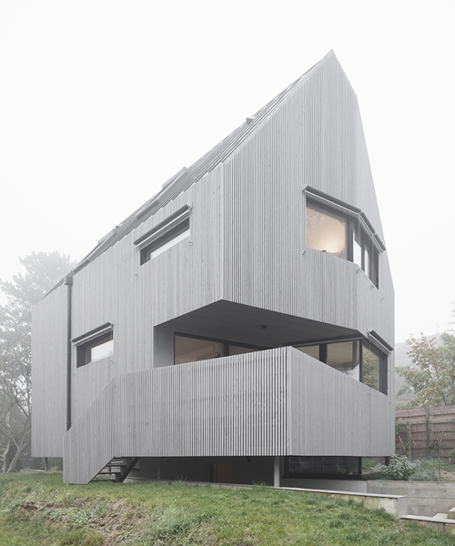 karawitz wraps asymmetric home entirely in grey larch wood in france