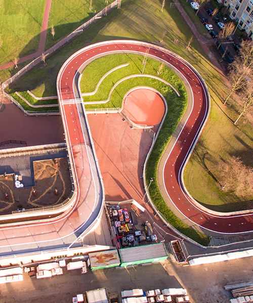 this bridge in utrecht allows cyclists to bike over the roof of school