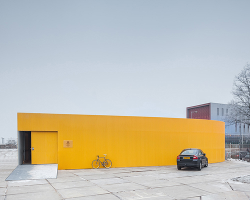 space encounters' mellow-yellow healthcare centre revives industrial hub in amsterdam