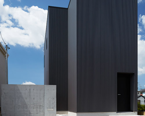 TAKATINA completes elevated black box house in suburban japan